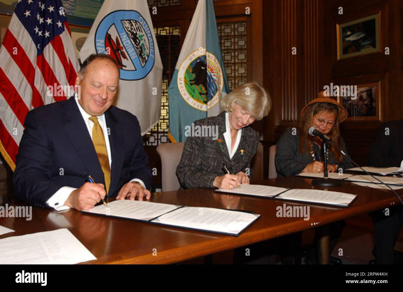 Assistant Attorney General for Environmental and Natural Resources, Thomas Sansonetti, Secretary Gale Norton, and President of the Quinault Indians, Pearl Capoeman-Baller, left to right, at signing event for agreement protecting forest habitat of marbled murrelet and other species in Washington state Stock Photo