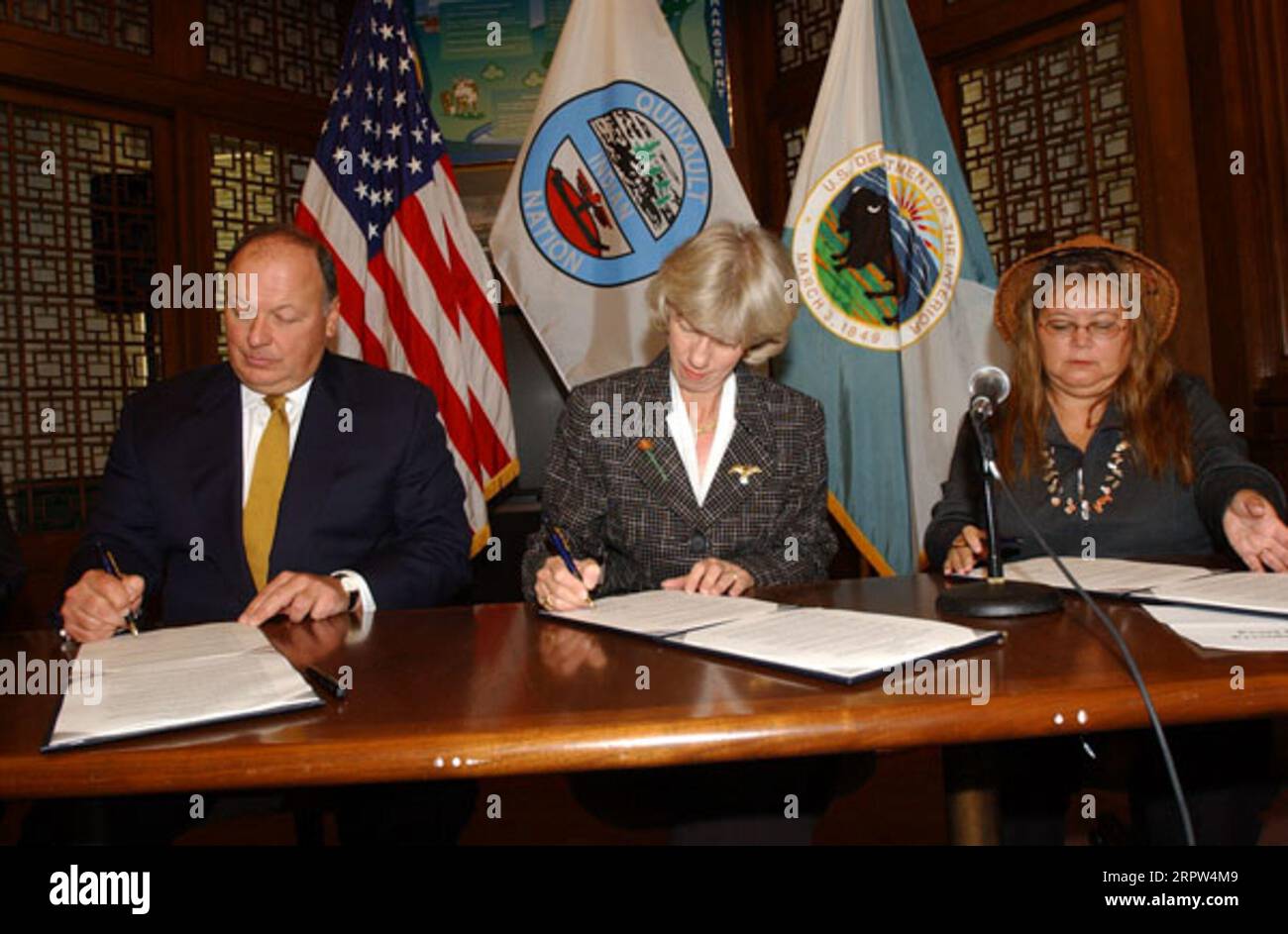 Assistant Attorney General for Environmental and Natural Resources, Thomas Sansonetti, Secretary Gale Norton, and President of the Quinault Indians, Pearl Capoeman-Baller, left to right, at signing event for agreement protecting forest habitat of marbled murrelet and other species in Washington state Stock Photo