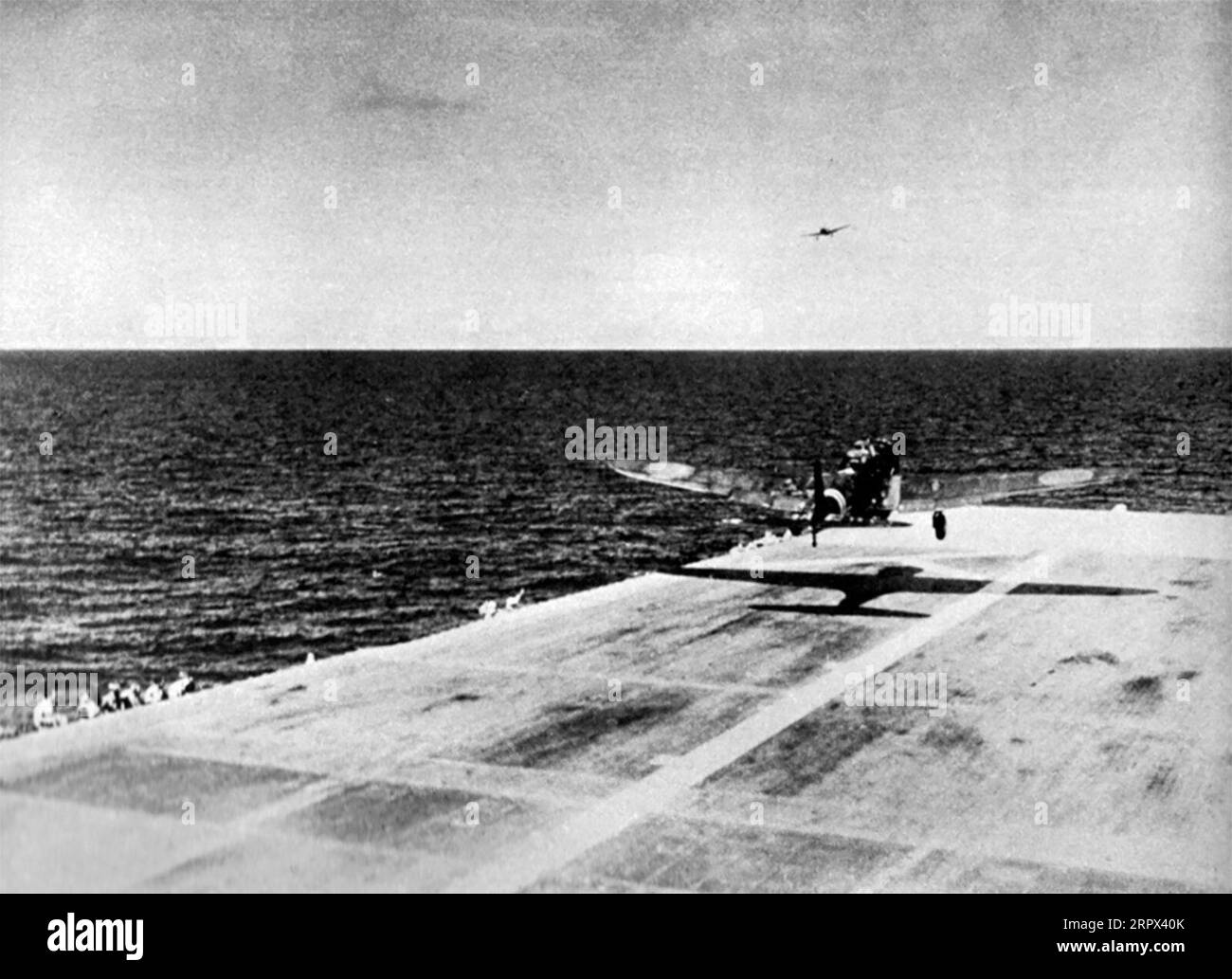 A Japanese B5N2 Kate taking off from the flight deck of the aircraft carrier Zuikaku for the attack on Pearl Harbor, at about 07:20h on 7 December 1941. Note the Aichi D3A1 Val in the background. Date 7 December 1941 Stock Photo