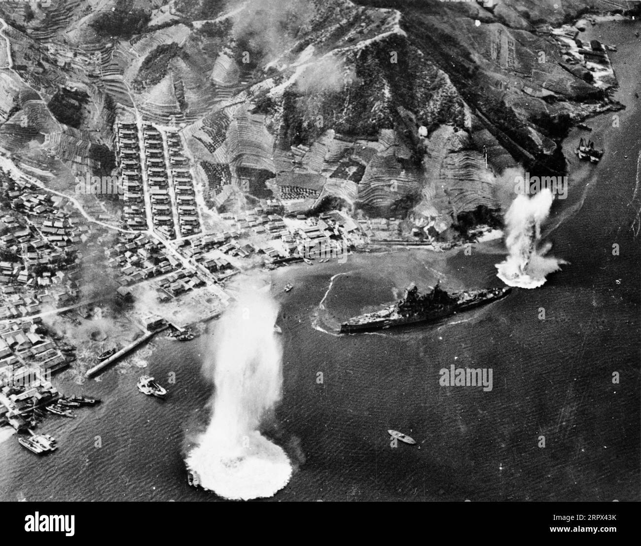U.S. Navy carrier aircraft attack the Japanese battleship Haruna at her moorings near Kure, Japan, 28 July 1945. Stock Photo