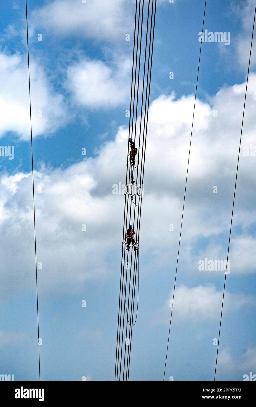 200509 -- ZHEN AN, May 9, 2020 -- Workers install overhead power lines for an 800KV direct current electricity transmission project linking northwest China s Qinghai Province and central China s Henan Province, in Zhen an County of northwest China s Shaanxi Province, May 8, 2020.  CHINA-SHAANXI-INFRASTRUCTURE-ELECTRICITY-CONSTRUCTION CN TaoxMing PUBLICATIONxNOTxINxCHN Stock Photo