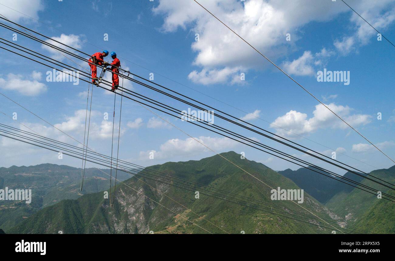 200509 -- ZHEN AN, May 9, 2020 -- In this aerial photo taken on May 8, 2020, workers install overhead power lines for an 800KV direct current electricity transmission project linking northwest China s Qinghai Province and central China s Henan Province, in Zhen an County of northwest China s Shaanxi Province.  CHINA-SHAANXI-INFRASTRUCTURE-ELECTRICITY-CONSTRUCTION CN TaoxMing PUBLICATIONxNOTxINxCHN Stock Photo