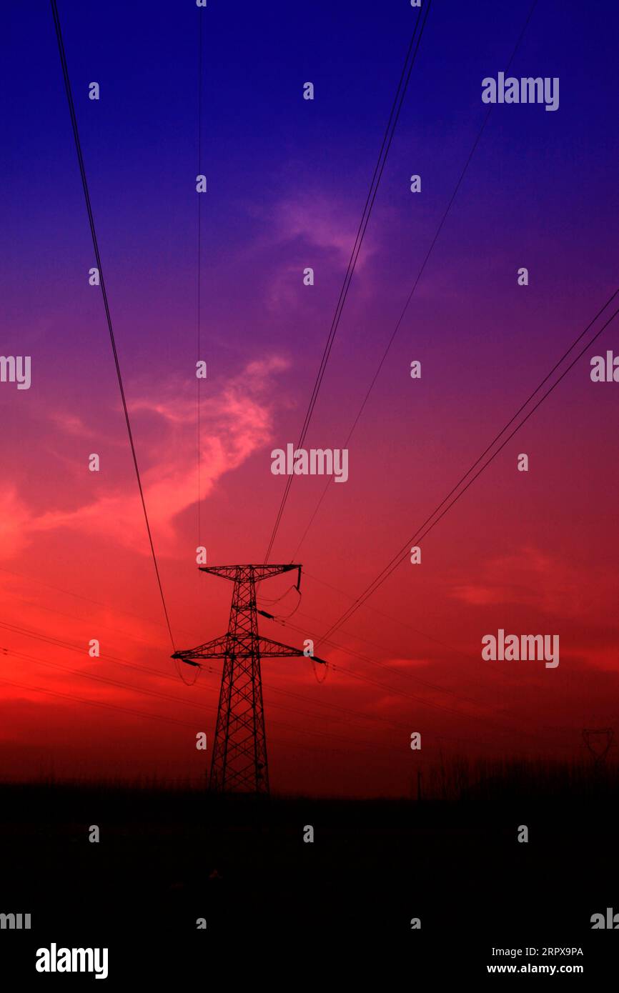 electric tower in the evening sky, power transmission facilities Stock Photo Alamy