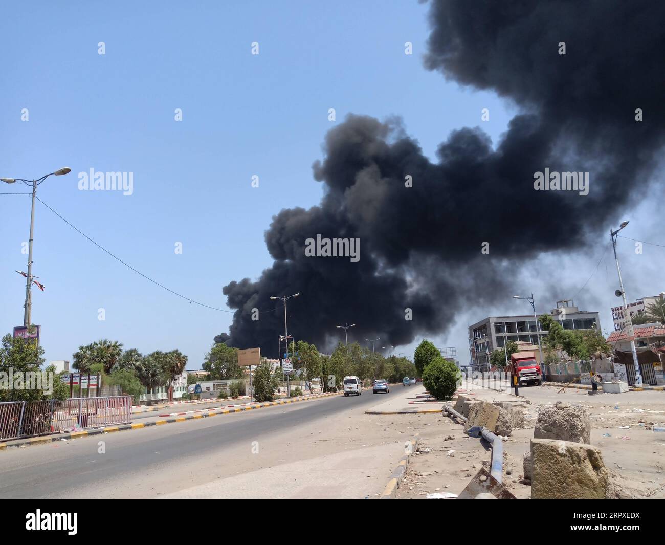 200519 -- ADEN, May 19, 2020 Xinhua -- Plumes of smoke rise after an oil truck-car collision in Aden, Yemen, May 19, 2020. Two people were killed and three others were injured after an oil carrier truck and a car collided in Yemen s southern port city of Aden on Tuesday, a security official told Xinhua. Photo by Murad Abdo/Xinhua YEMEN-ADEN-VEHICLE-COLLISION PUBLICATIONxNOTxINxCHN Stock Photo