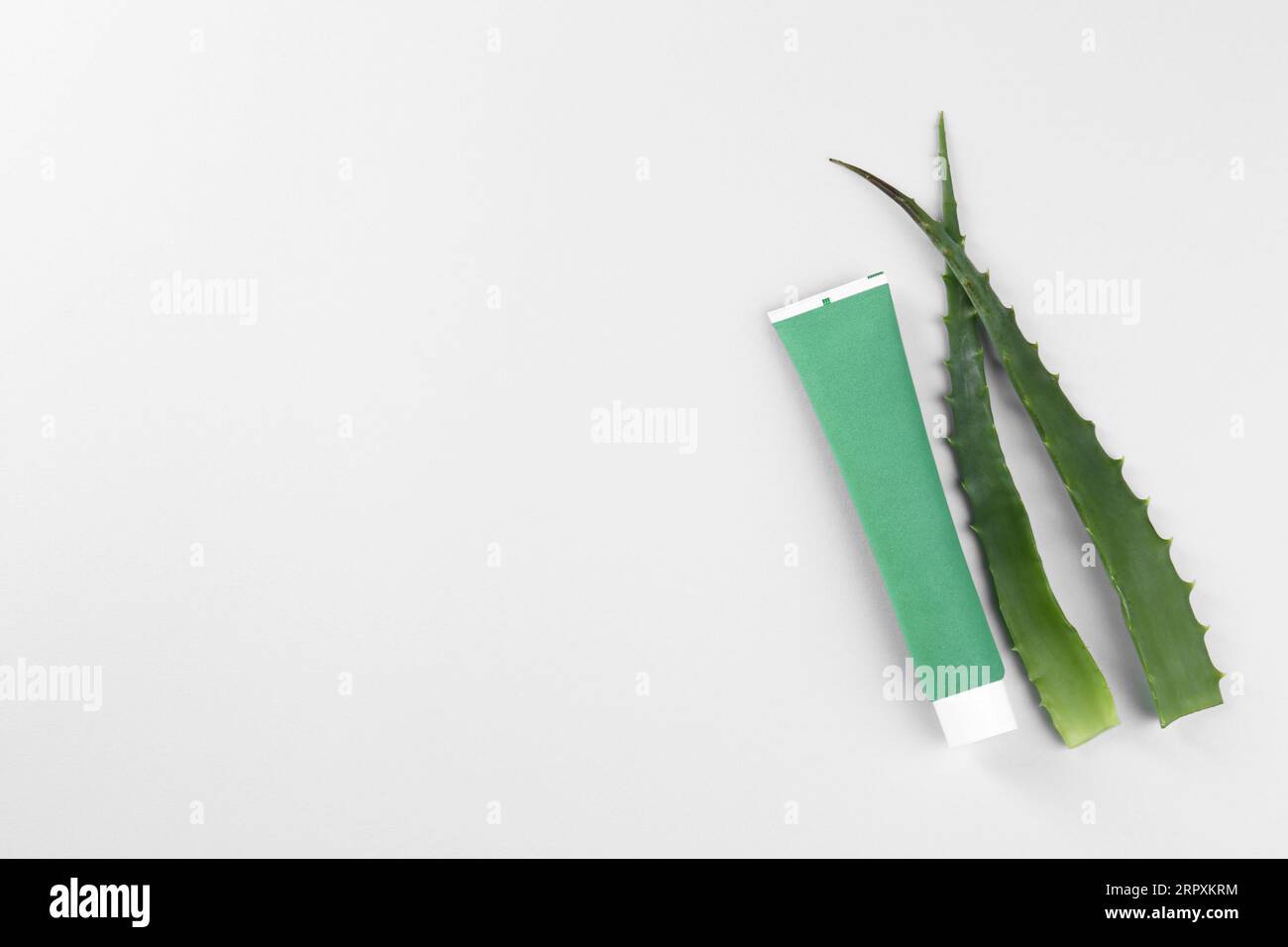 Tube of toothpaste and fresh aloe on white background, top view Stock ...