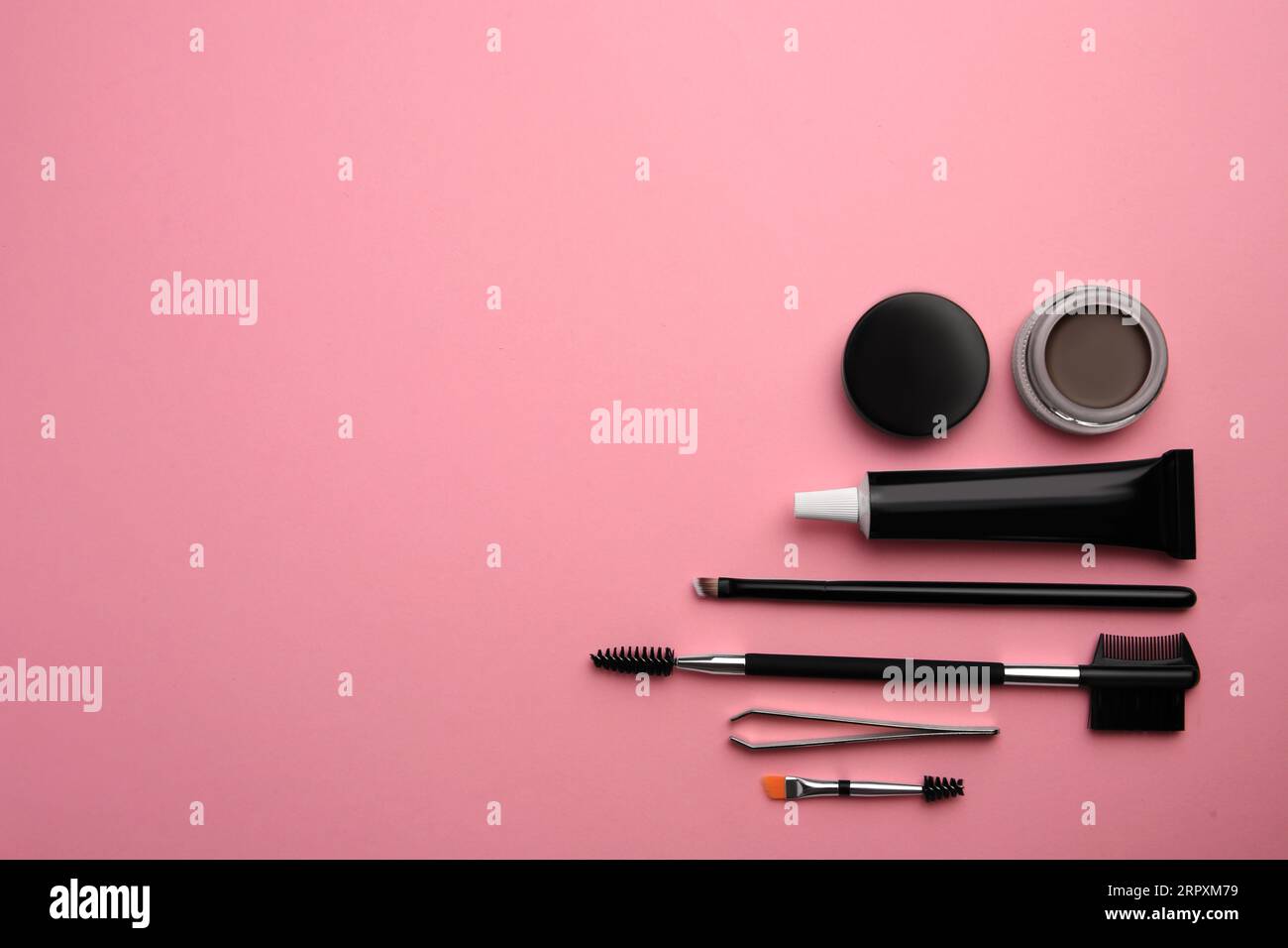 Flat lay composition with eyebrow henna and tools on pink background. Space for text Stock Photo