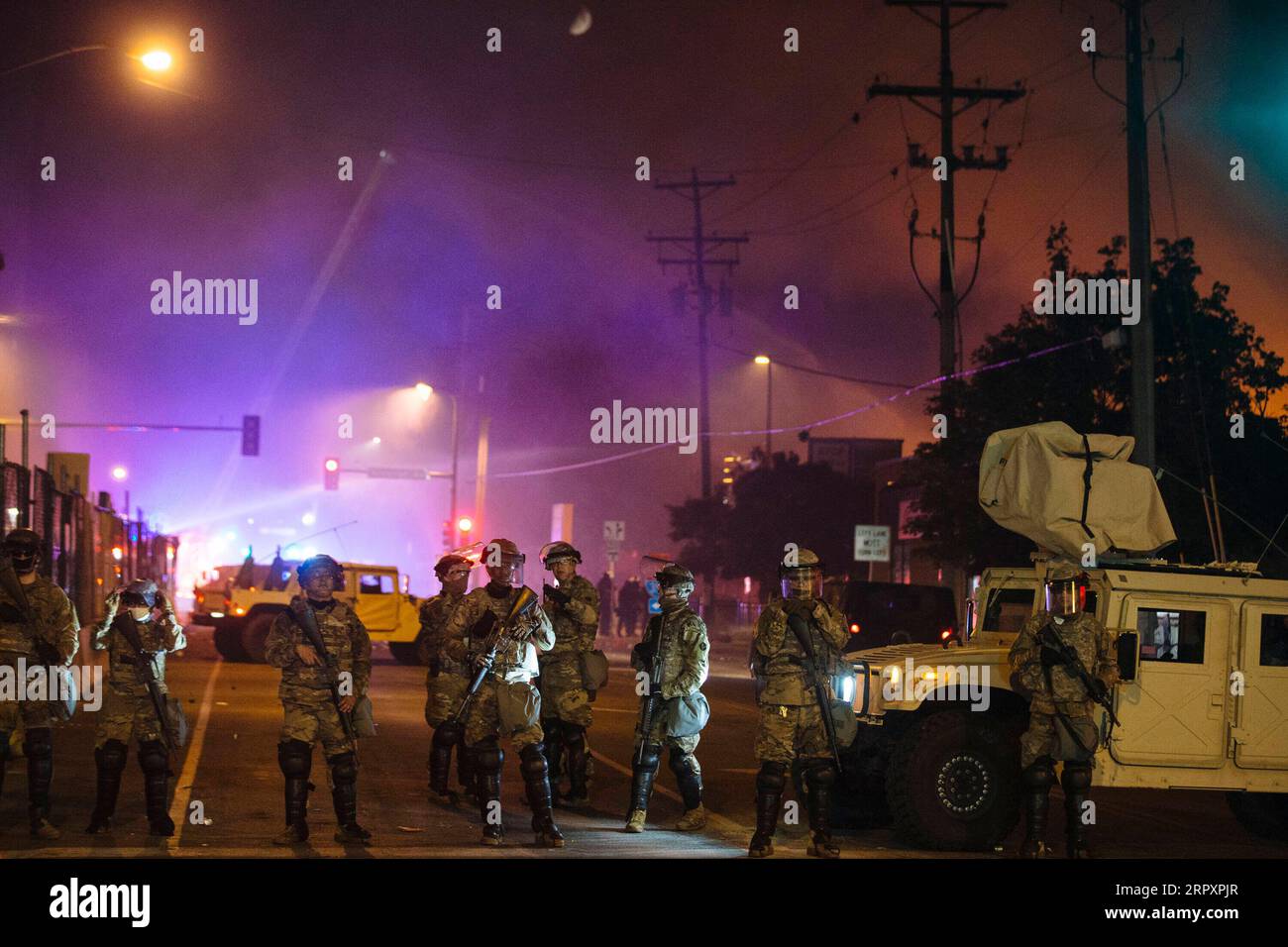 200531 -- MINNEAPOLIS, May 31, 2020 Xinhua -- Members of the Minnesota National Guard block the road while firefighters extinguish a fire set in a Wells Fargo bank by protesters earlier in the night in Minneapolis, the United States, on May 30, 2020. Thousands of protesters took to the streets of Minneapolis Friday night, defying a citywide 8 p.m. curfew that had been announced earlier that day. Businesses were burned and vandalized, as the rioting continued, said local media reports. Photo by Angus Alexander/Xinhua U.S.-MINNEAPOLIS-PROTEST-AFTERMATH PUBLICATIONxNOTxINxCHN Stock Photo