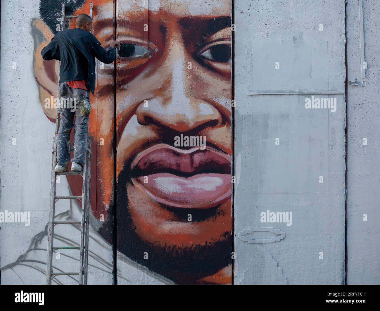 200610 -- BETHLEHEM, June 10, 2020 Xinhua -- Palestinian artist Taqi Spateen paints a mural of George Floyd on the Israeli separation wall in the West Bank city of Bethlehem, June 9, 2020. Photo by Luay Sababa/Xinhua MIDEAST-BETHLEHEM-GEORGE FLOYD-MURAL PUBLICATIONxNOTxINxCHN Stock Photo
