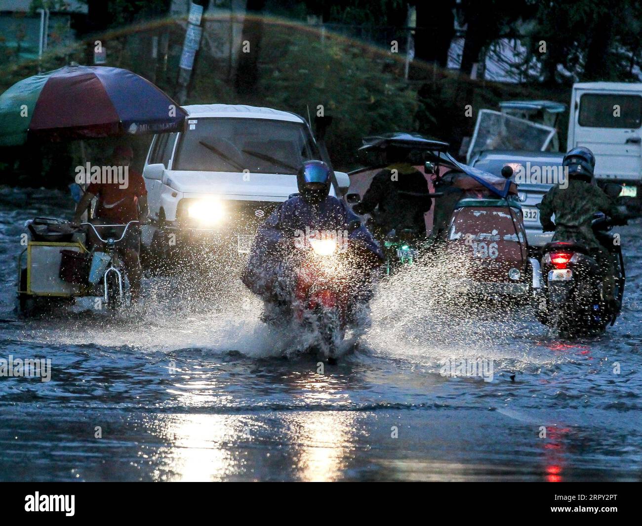 200611 -- MANILA, June 11, 2020 -- People ride their vehicles through a flooded area caused by the heavy rain from the tropical depression locally named Butchoy in Manila, the Philippines, on June 11, 2020.  PHILIPPINES-MANILA-TROPICAL DEPRESSION BUTCHOY ROUELLExUMALI PUBLICATIONxNOTxINxCHN Stock Photo