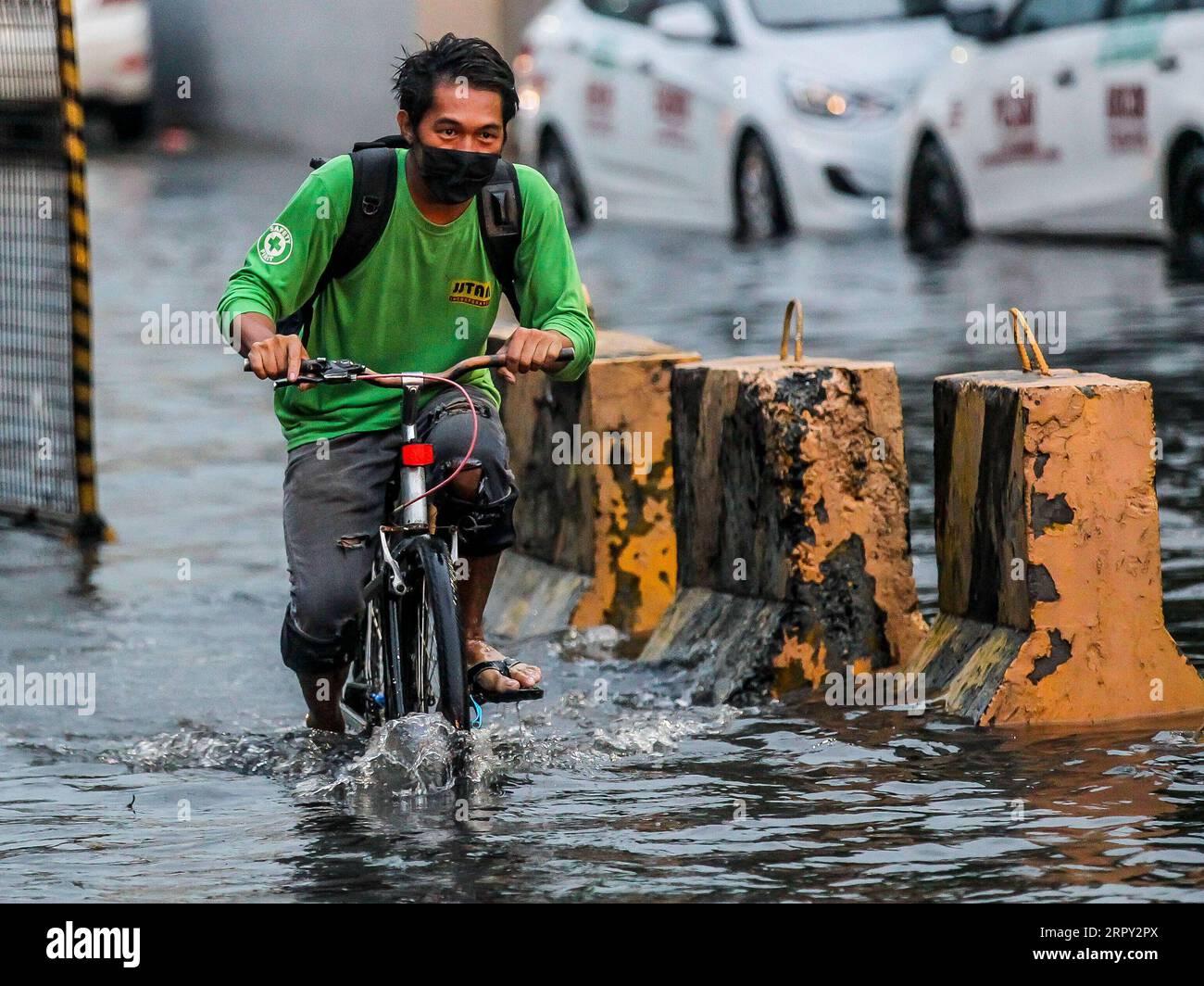 200611 -- MANILA, June 11, 2020 -- A man rides his bicycle through a flooded area caused by the heavy rain from the tropical depression locally named Butchoy in Manila, the Philippines, on June 11, 2020.  PHILIPPINES-MANILA-TROPICAL DEPRESSION BUTCHOY ROUELLExUMALI PUBLICATIONxNOTxINxCHN Stock Photo