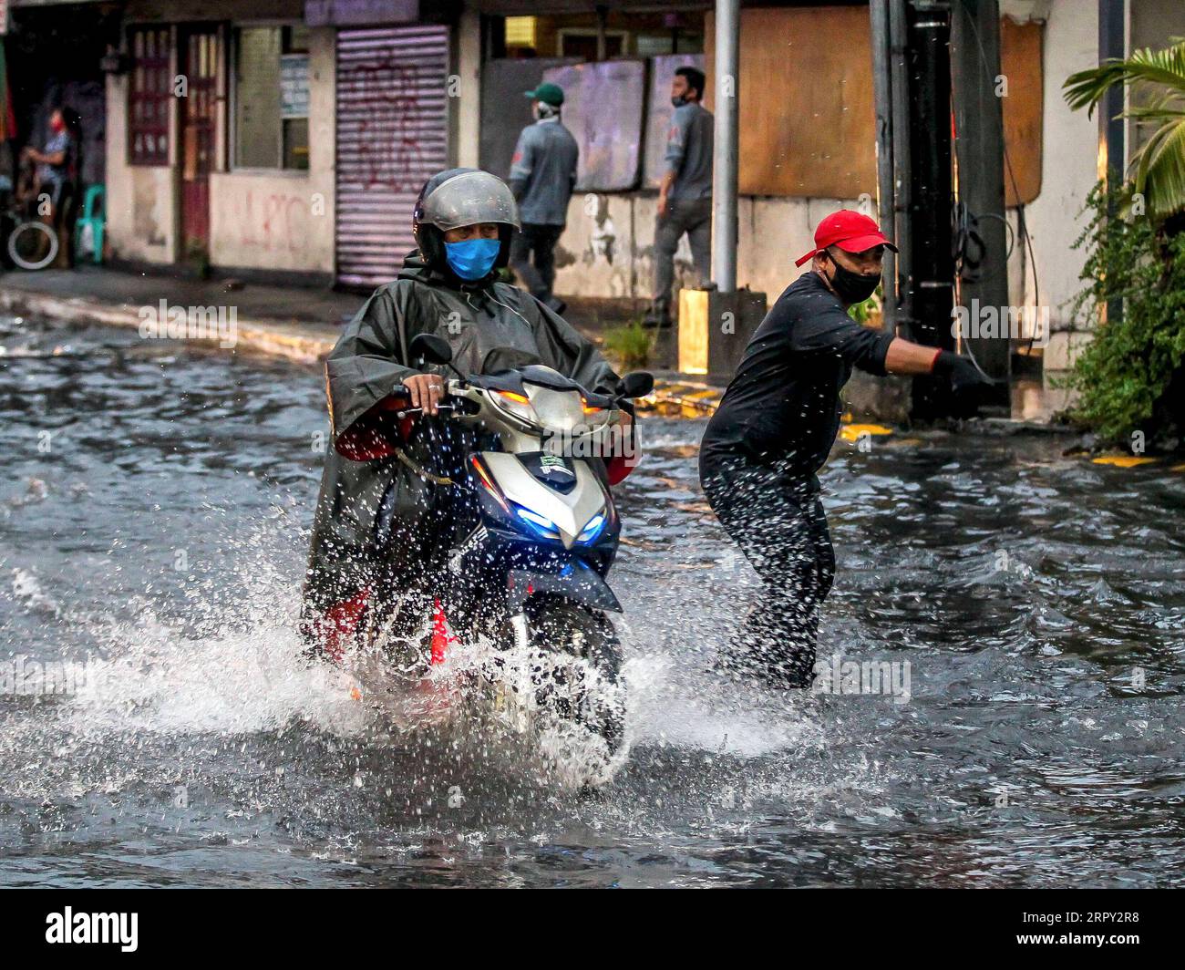 200611 -- MANILA, June 11, 2020 -- A man rides his motorbike through a flooded area caused by the heavy rain from the tropical depression locally named Butchoy in Manila, the Philippines, on June 11, 2020.  PHILIPPINES-MANILA-TROPICAL DEPRESSION BUTCHOY ROUELLExUMALI PUBLICATIONxNOTxINxCHN Stock Photo