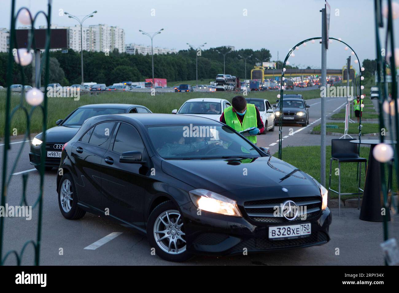 200612 -- MOSCOW, June 12, 2020 Xinhua -- A cinema employee checks the visitors list at the entrance of a new drive-in cinema at a mall outside Moscow, Russia, on June 11, 2020. Photo by Alexander Zemlianichenko Jr/Xinhua RUSSIA-MOSCOW-DRIVE-IN CINEMA PUBLICATIONxNOTxINxCHN Stock Photo