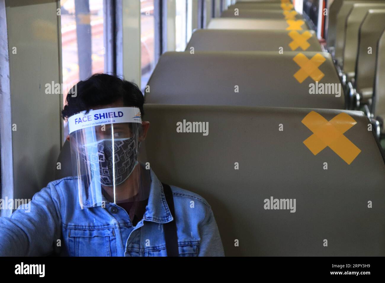 200612 -- SURABAYA, June 12, 2020 -- A passenger wearing a face shield takes a train in Surabaya, Indonesia, June 12, 2020. The COVID-19 cases in Indonesia rose by 1,111 within one day to 36,406, with the death toll adding by 48 to 2,048, Achmad Yurianto, a Health Ministry official, said at a press conference here on Friday. Photo by /Xinhua INDONESIA-SURABAYA-COVID-19-CASES SuryaxBetha PUBLICATIONxNOTxINxCHN Stock Photo