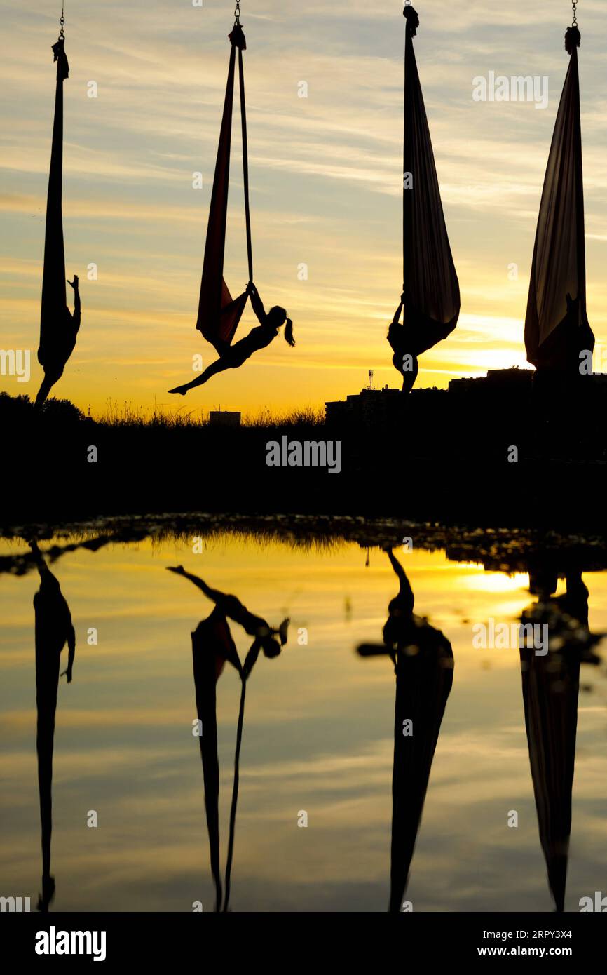 200612 -- ZAGREB, June 12, 2020 Xinhua -- Members of Triko Circus Theater perform aerial hammock dance by hanging from the Mladost Bridge over Sava River in Zagreb, Croatia, on June 11, 2020. Borna Filic/Pixsell via Xinhua CROATIA-ZAGREB-AERIAL HAMMOCK DANCE PUBLICATIONxNOTxINxCHN Stock Photo