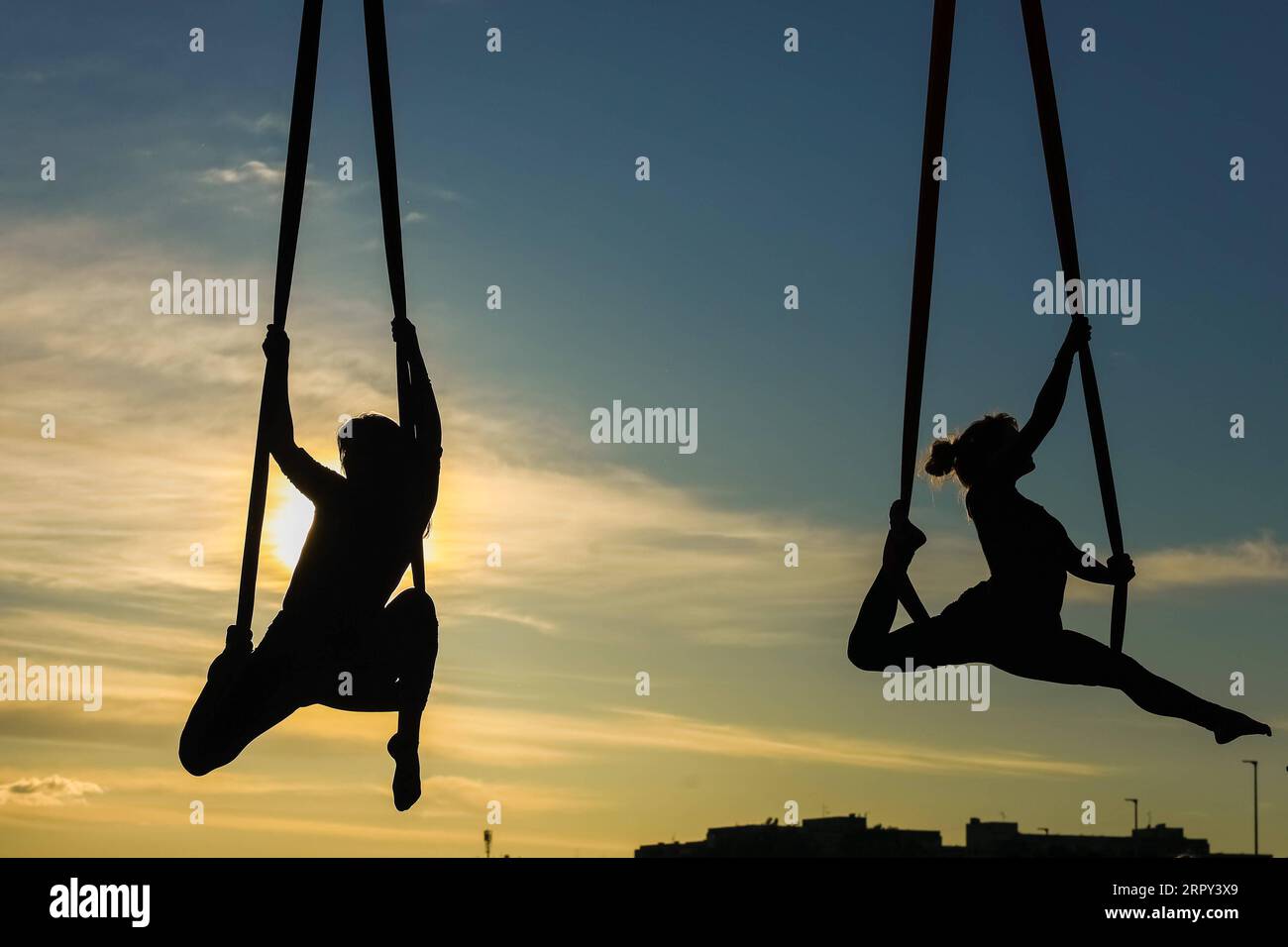 200612 -- ZAGREB, June 12, 2020 Xinhua -- Members of Triko Circus Theater perform aerial hammock dance by hanging from the Mladost Bridge over Sava River in Zagreb, Croatia, on June 11, 2020. Borna Filic/Pixsell via Xinhua CROATIA-ZAGREB-AERIAL HAMMOCK DANCE PUBLICATIONxNOTxINxCHN Stock Photo