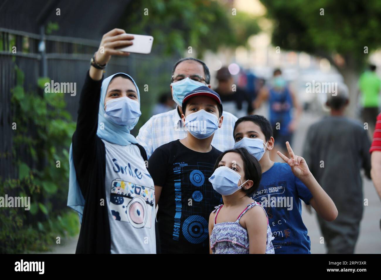 200612 -- CAIRO, June 12, 2020 Xinhua -- People wearing face masks take selfies on a street in Cairo, Egypt, on June 12, 2020. Egypt witnessed on Friday a record of 1,577 single-day new COVID-19 cases, raising the total infections confirmed in the country since mid-February to 41,303, said spokesman with the Health Ministry. Xinhua/Ahmed Gomaa EGYPT-CAIRO-COVID-19-CASES PUBLICATIONxNOTxINxCHN Stock Photo