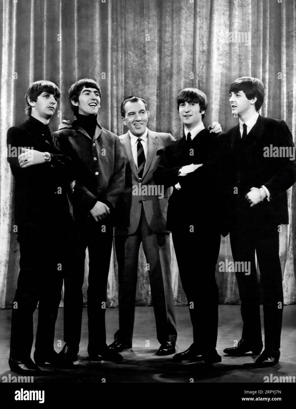 The Beatles appearing with Ed Sullivan in the United States on the Ed Sullivan Show on February 9, 1964. (USA) Stock Photo