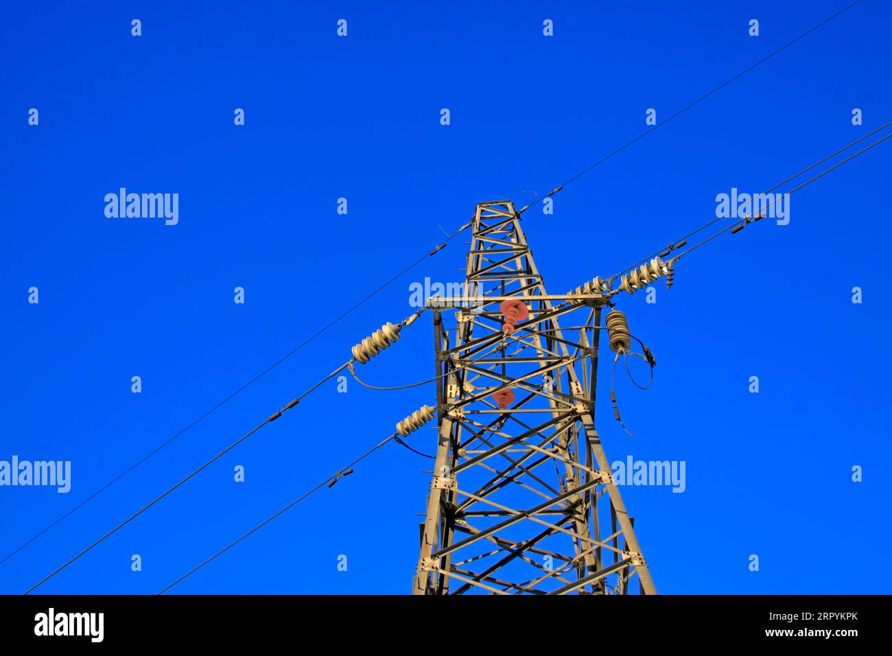 Electric power tower under the blue sky, closeup of photo Stock Photo