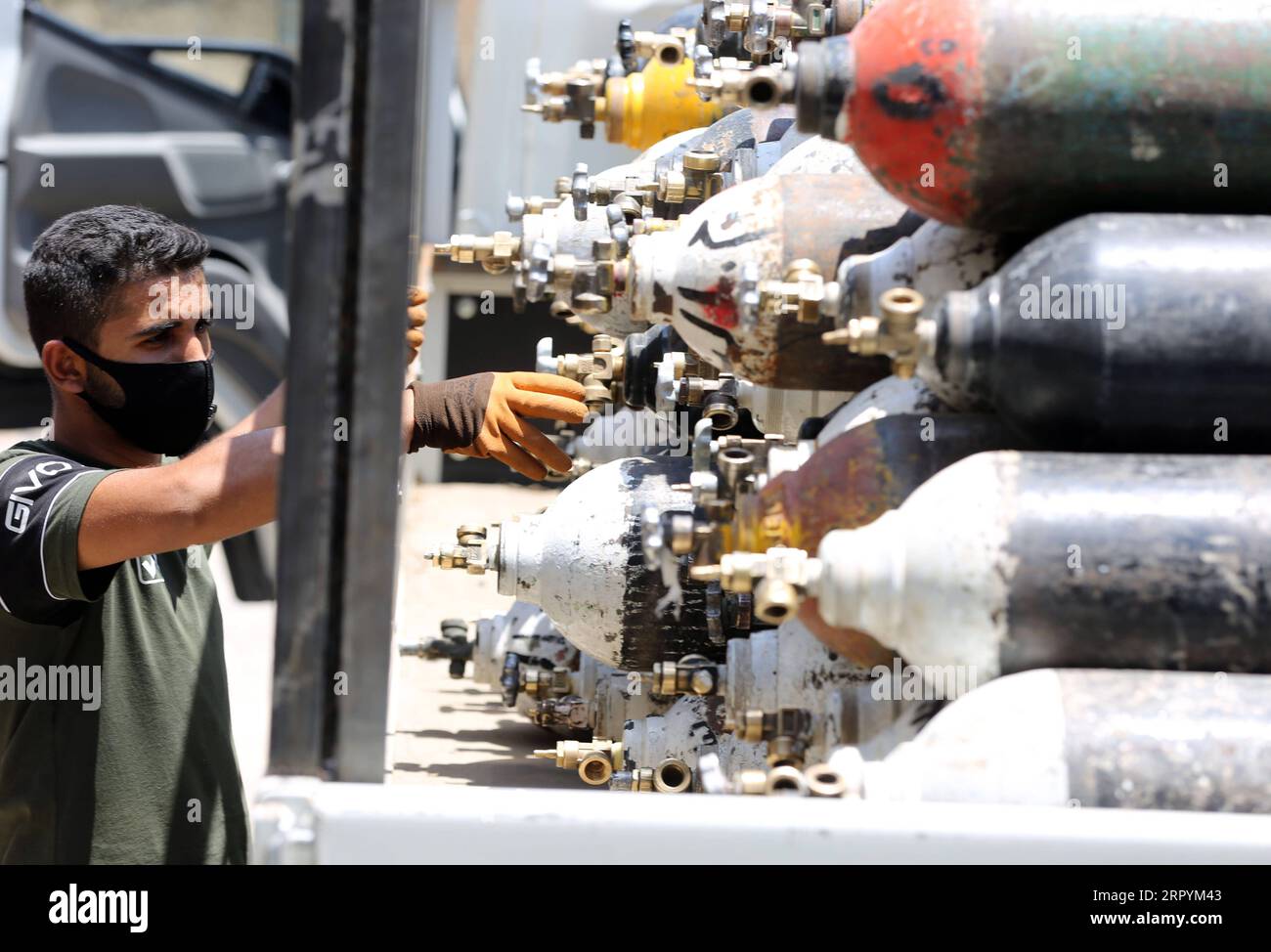 200707 -- BAGHDAD, July 7, 2020 Xinhua -- A worker checks oxygen cylinders to be delivered to hospitals at an oxygen refilling station in Baghdad, Iraq, on July 7, 2020. A government-owned oxygen filling factory in Iraq has increased its filling of oxygen cylinders and the liquid gas to meet the demand of the Iraqi hospitals amid the continued rise in COVID-19 infections. The resurgence of COVID-19 pandemic continued in Iraq on Tuesday, as the Iraqi Health Ministry confirmed 2,426 new cases, bringing the total number of coronavirus infections nationwide to 64,701. Xinhua IRAQ-BAGHDAD-COVID-19- Stock Photo