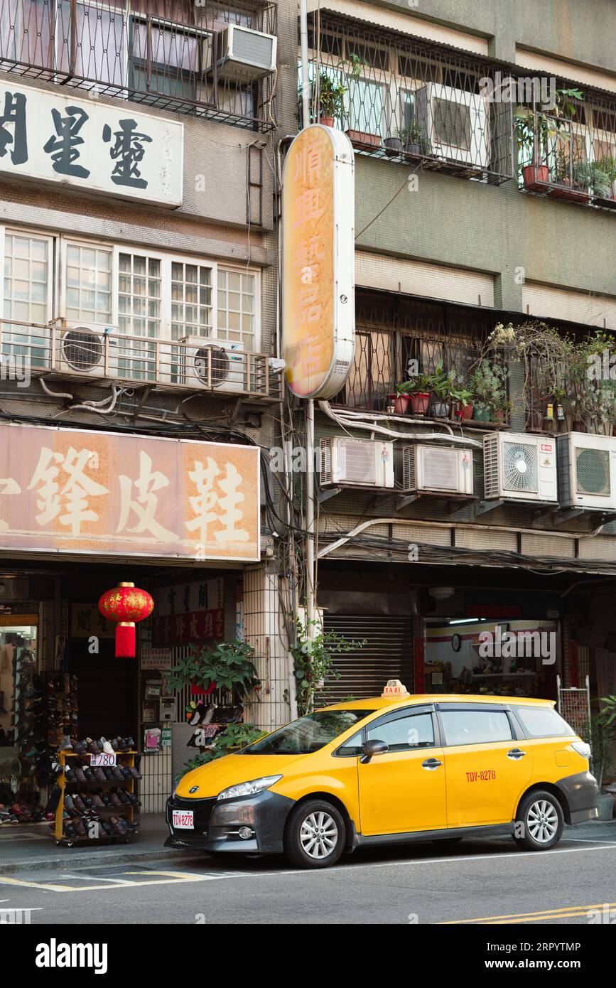 Taipei, Taiwan - 23 March, 2023 : Retro street old building and yellow taxi Stock Photo