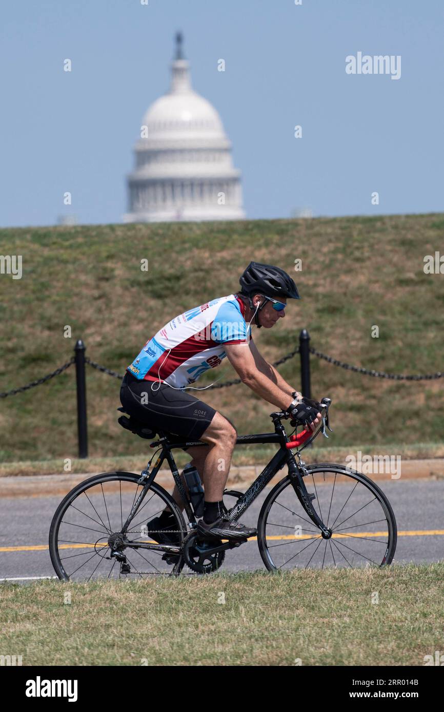 200721 -- WASHINGTON, July 21, 2020 -- A man rides a bicycle with the U.S. Capitol Building in the background in Washington, D.C., the United States, on July 21, 2020. U.S. President Donald Trump said Tuesday afternoon that the coronavirus pandemic in the United States will probably get worse before it gets better. More than 3.8 million people in the United States have infected with the virus, with more than 141,000 deaths, according to a count by Johns Hopkins University, as some states, including Florida, are seeing a surge in cases.  U.S.-WASHINGTON, D.C.-TRUMP-CORONAVIRUS PANDEMIC LiuxJie Stock Photo