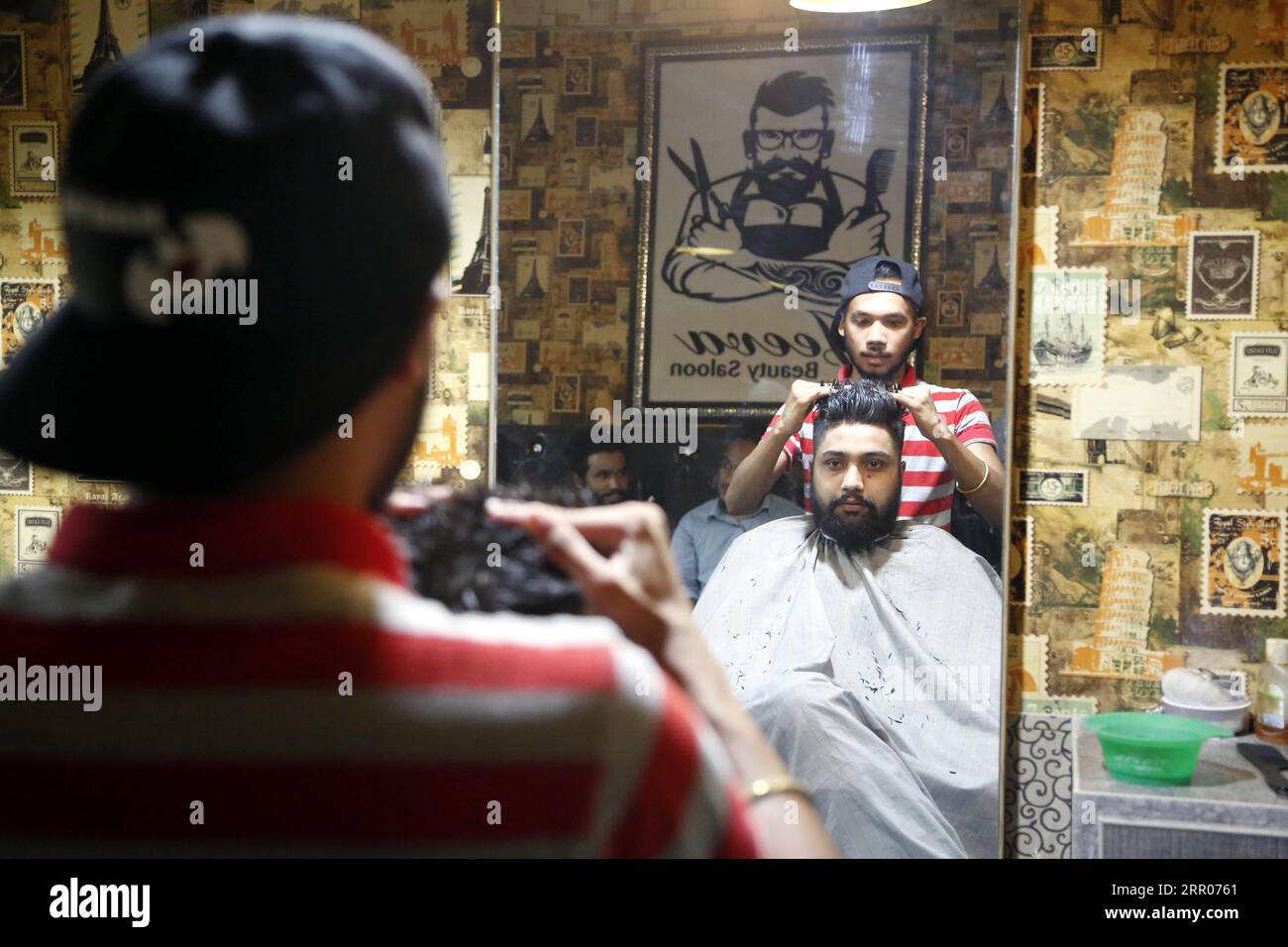 200731 RAWALPINDI PAKISTAN, July 31, 2020 A barber adjusts a