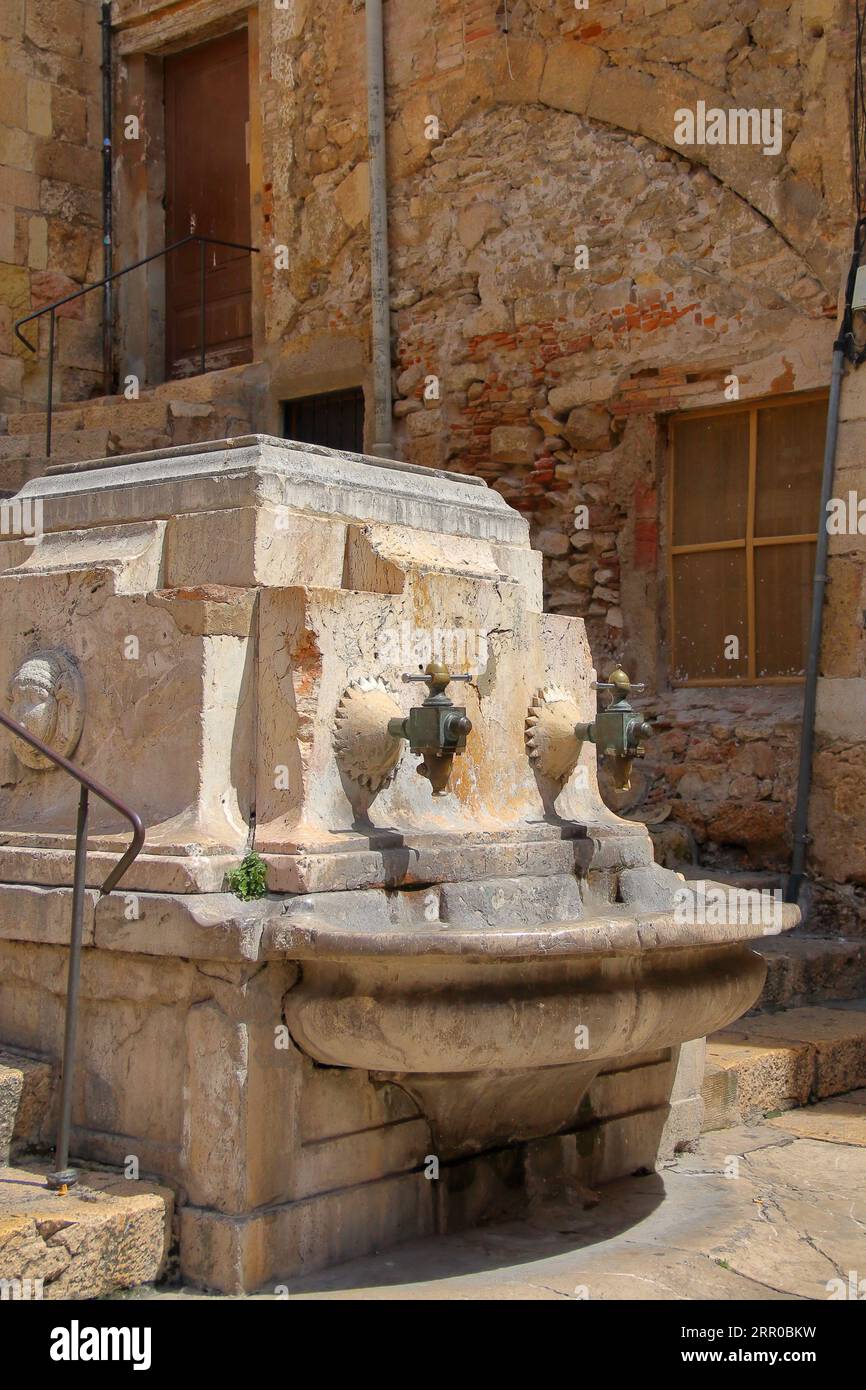 The photo shows old brass taps for water in the ancient Spanish city of