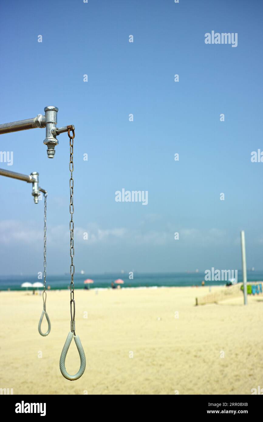 a public shower on the beach, vertical outdoor shot, no people Stock