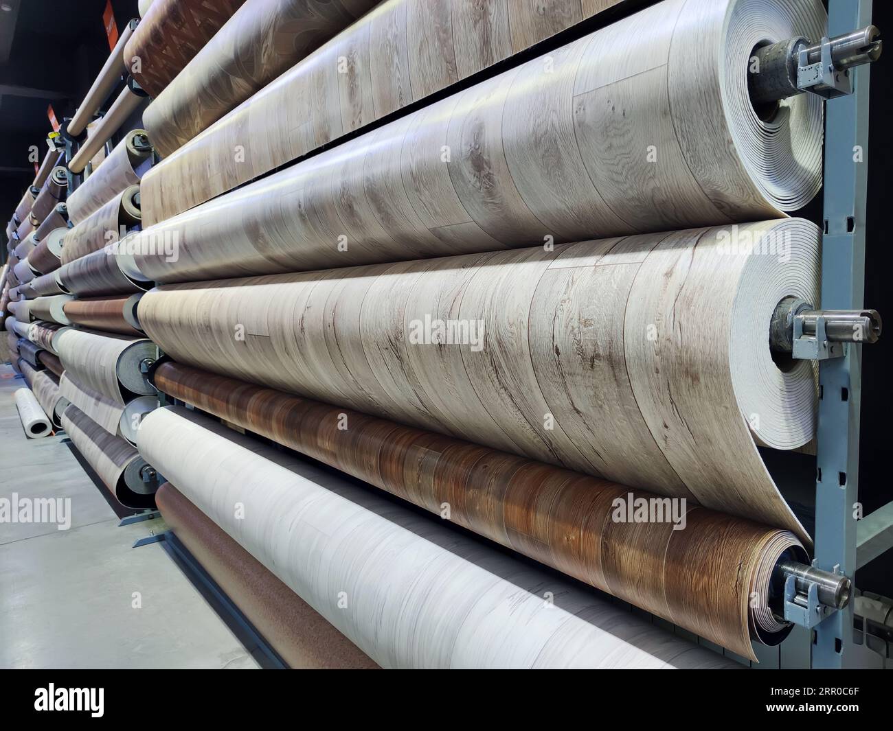 Rolls with linoleum in a shop window. Various types of flooring on sale at the bazaar. The rise in price of building materials concept. Stock Photo