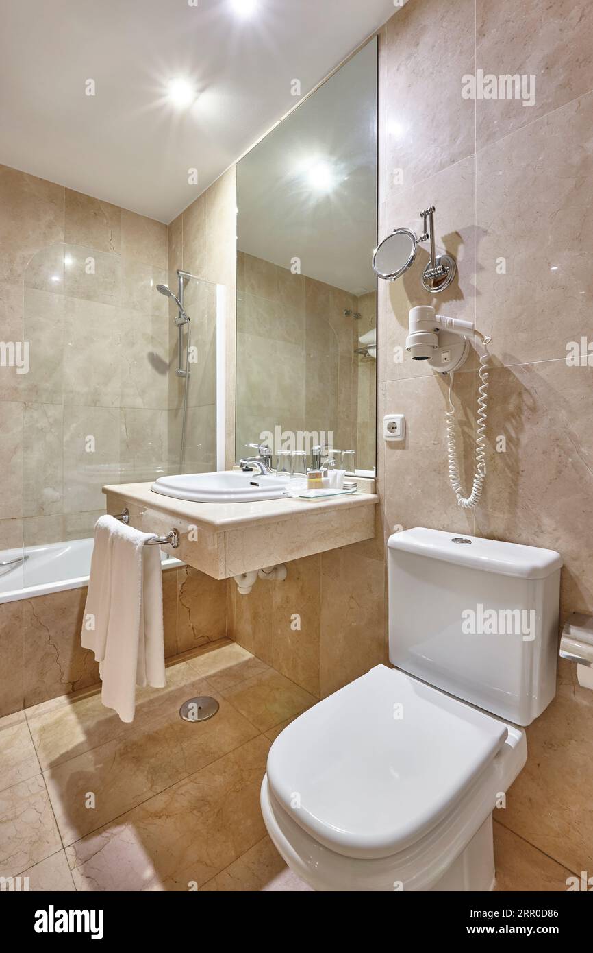 Bathroom finished in marble. Shower, lavatory, wash hand basin Stock Photo