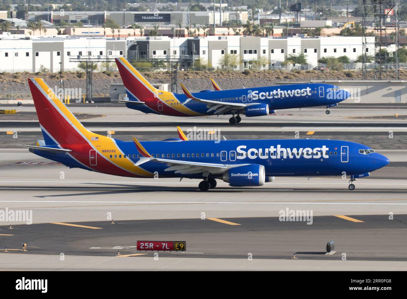 Two Southwest Airlines 737s, one landing and one taking off Stock Photo