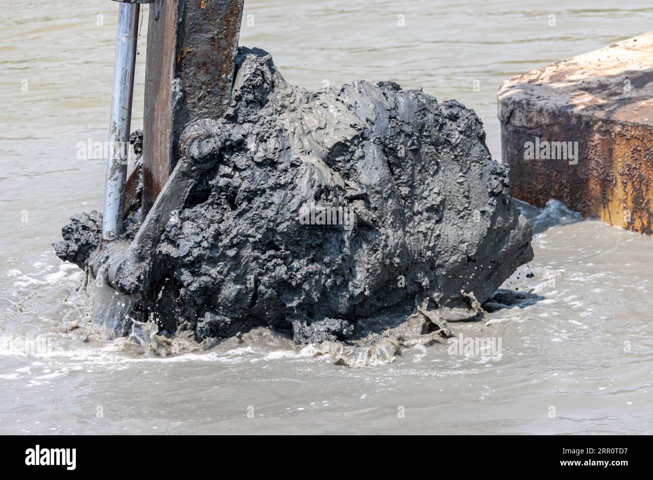 Dredging the bottom of water area, view of the bucket of the floating