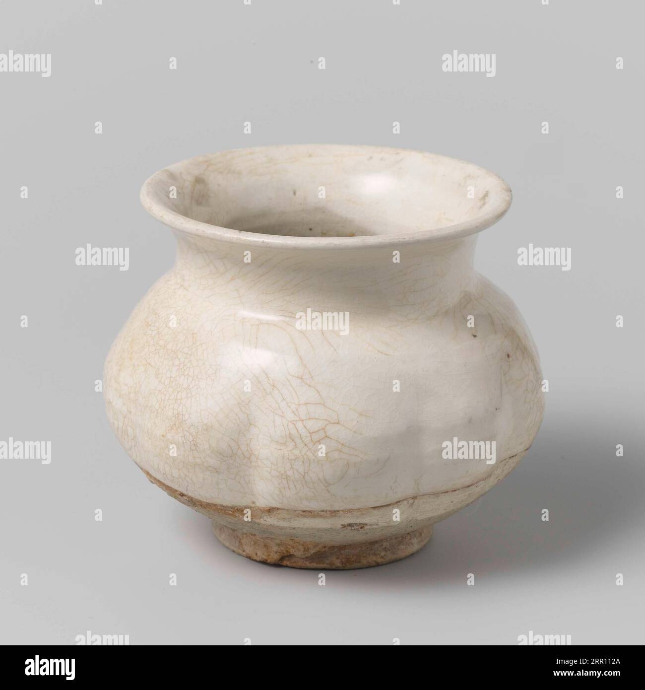 Pot of stoneware with a ribbed wall, partly covered with a white sludge ...