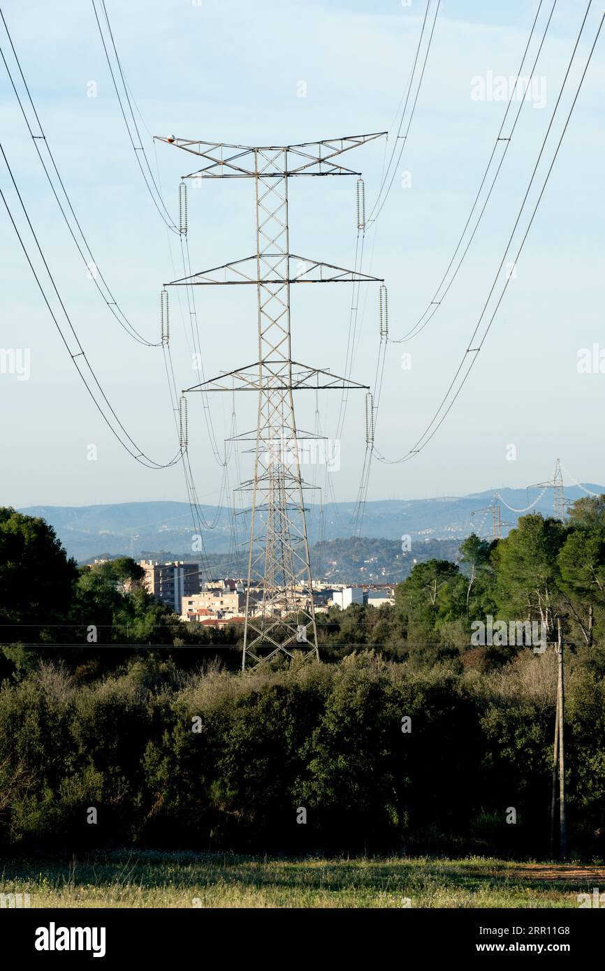 photograph captures a high tension tower with its cables leading the ...