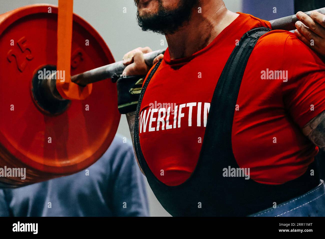 close-up red plates barbell and male powerlifter preparing for squat powerlifting Stock Photo