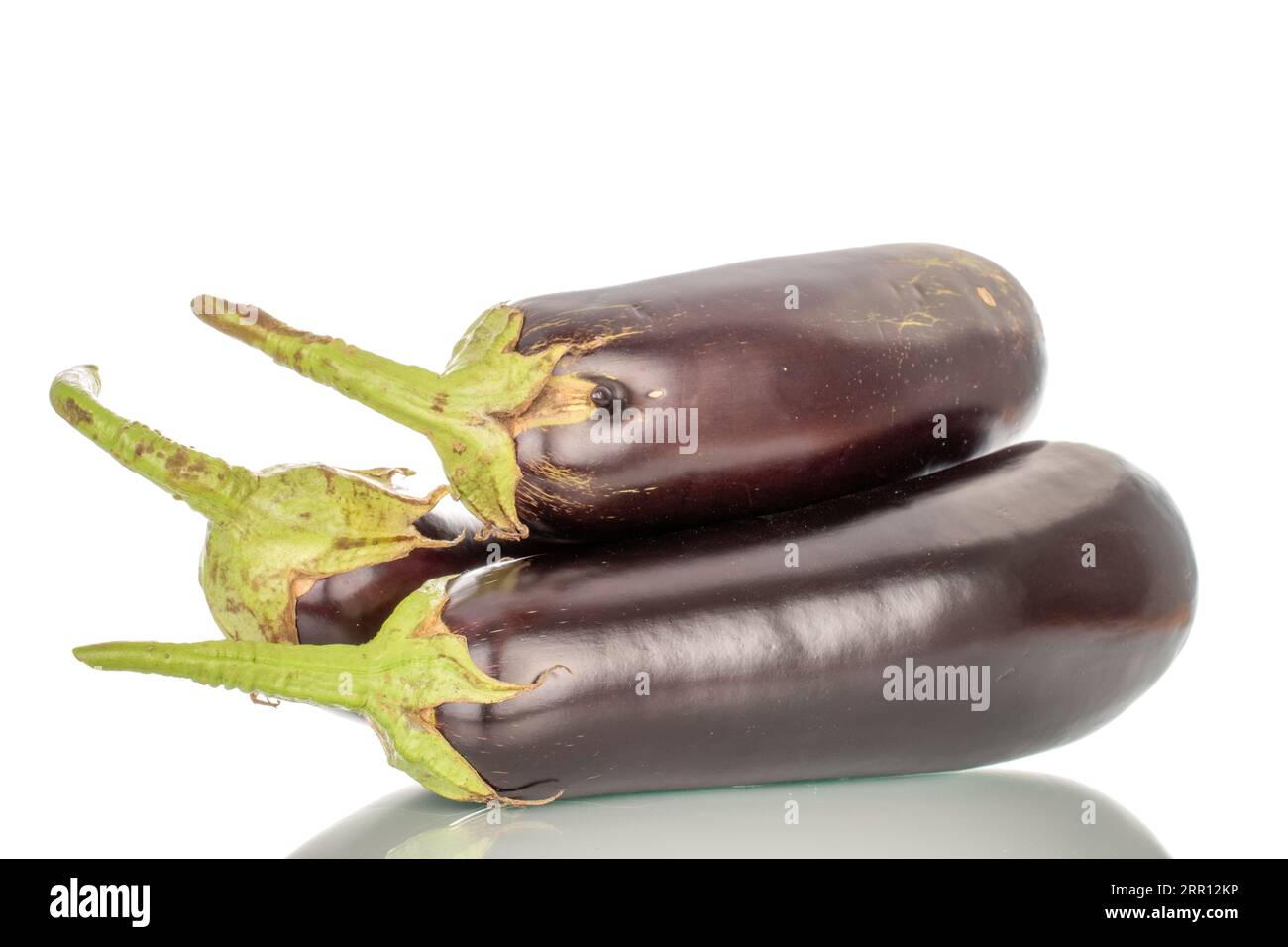 Three ripe eggplants, macro, isolated on white background. Stock Photo