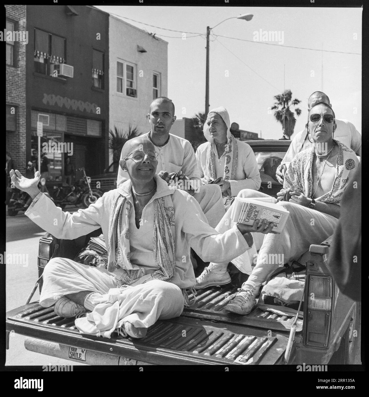 members of Hare Krishna movement  parade riding on back of pick-up truck during Daytona Bike Week in March 1986 in Daytona Beach, Florida, United States Stock Photo