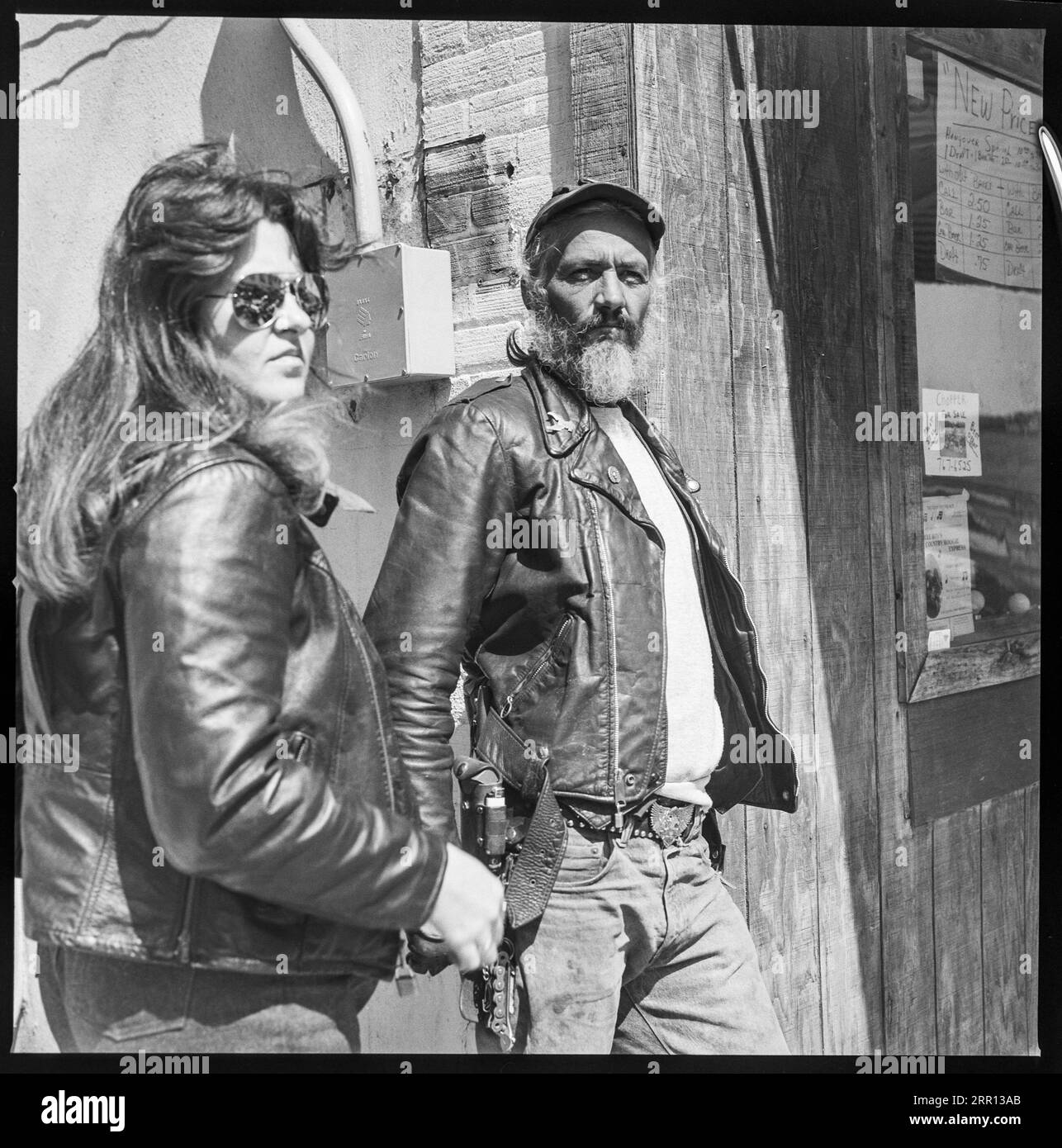 biker couple dressed in leather  hanging out during Daytona Bike Week in March 1986 in Daytona Beach, Florida, United States Stock Photo