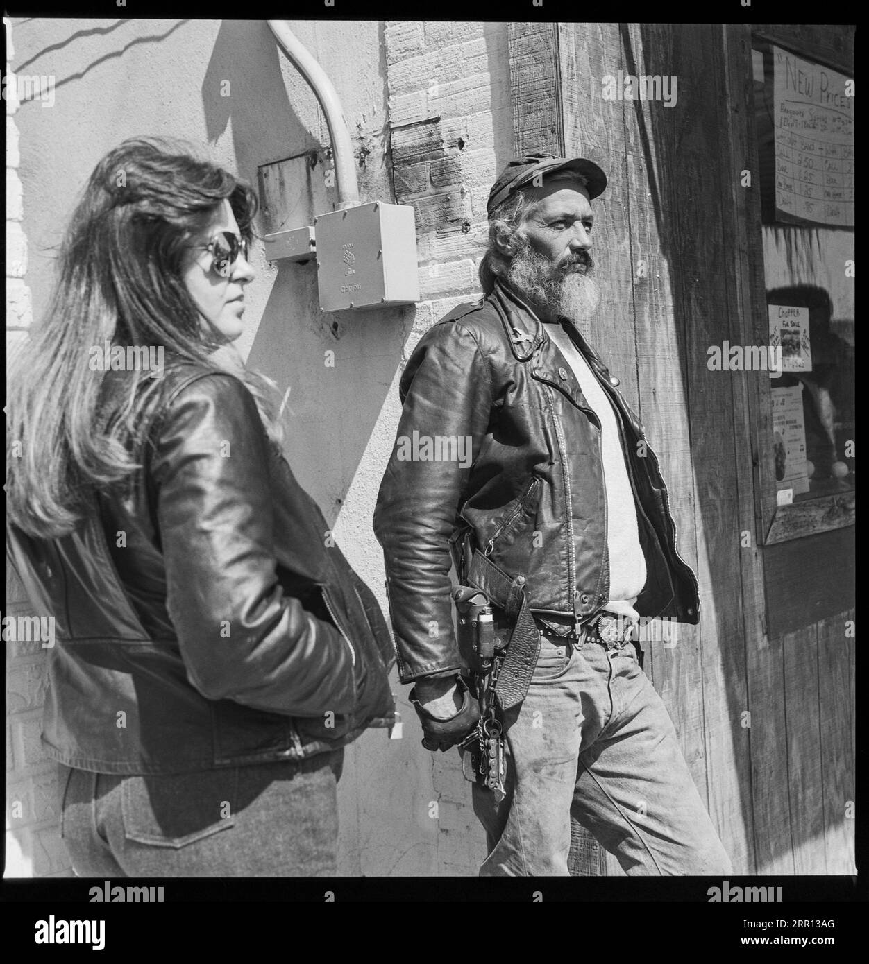 biker couple dressed in leather  hanging out during Daytona Bike Week in March 1986 in Daytona Beach, Florida, United States Stock Photo