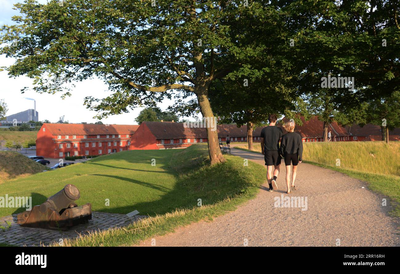 A couple walking in the park at the Kastellet, Copenhagen, Denmark. Stock Photo