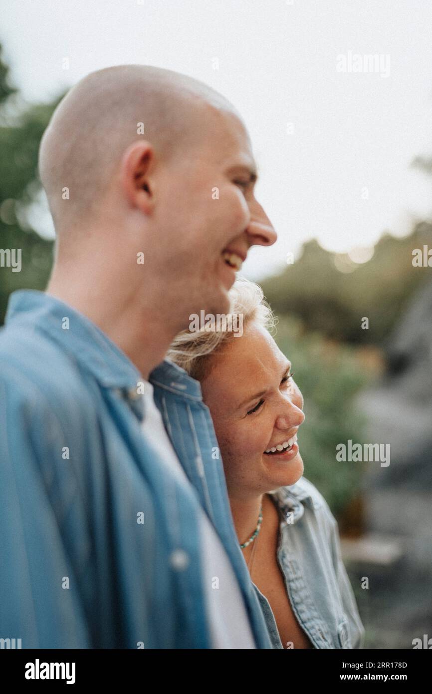 Man and woman laughing together during dinner party at cafe Stock Photo ...