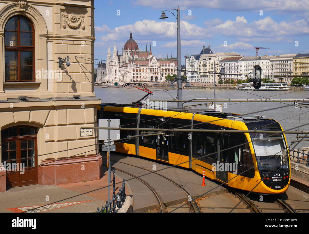 A tram on the Danube embankment with the parliament building across the River Danube in the background Stock Photo