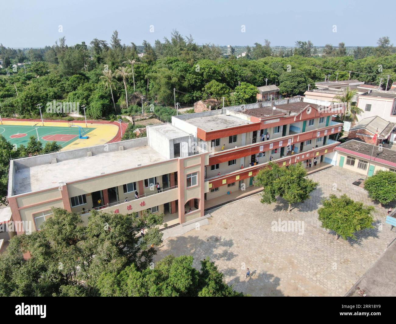 200909 -- GUANGZHOU, Sept. 9, 2020 -- Aerial photo taken on Sept. 1, 2020 shows the new teaching building and playground of Beili Primary School on Beili Island in Xuwen County, south China s Guangdong Province. Six years ago, Lin Xiaolian came to this island as a volunteer teacher after graduating from Lingnan Normal University in Guangdong. And then she chose to stay here to be a teacher. The remote and poverty-stricken island village of Beili hardly sees outsiders. There are no restaurants, hotels nor cars on the island covering only 7 square kilometers. Beili Primary School has over 300 st Stock Photo
