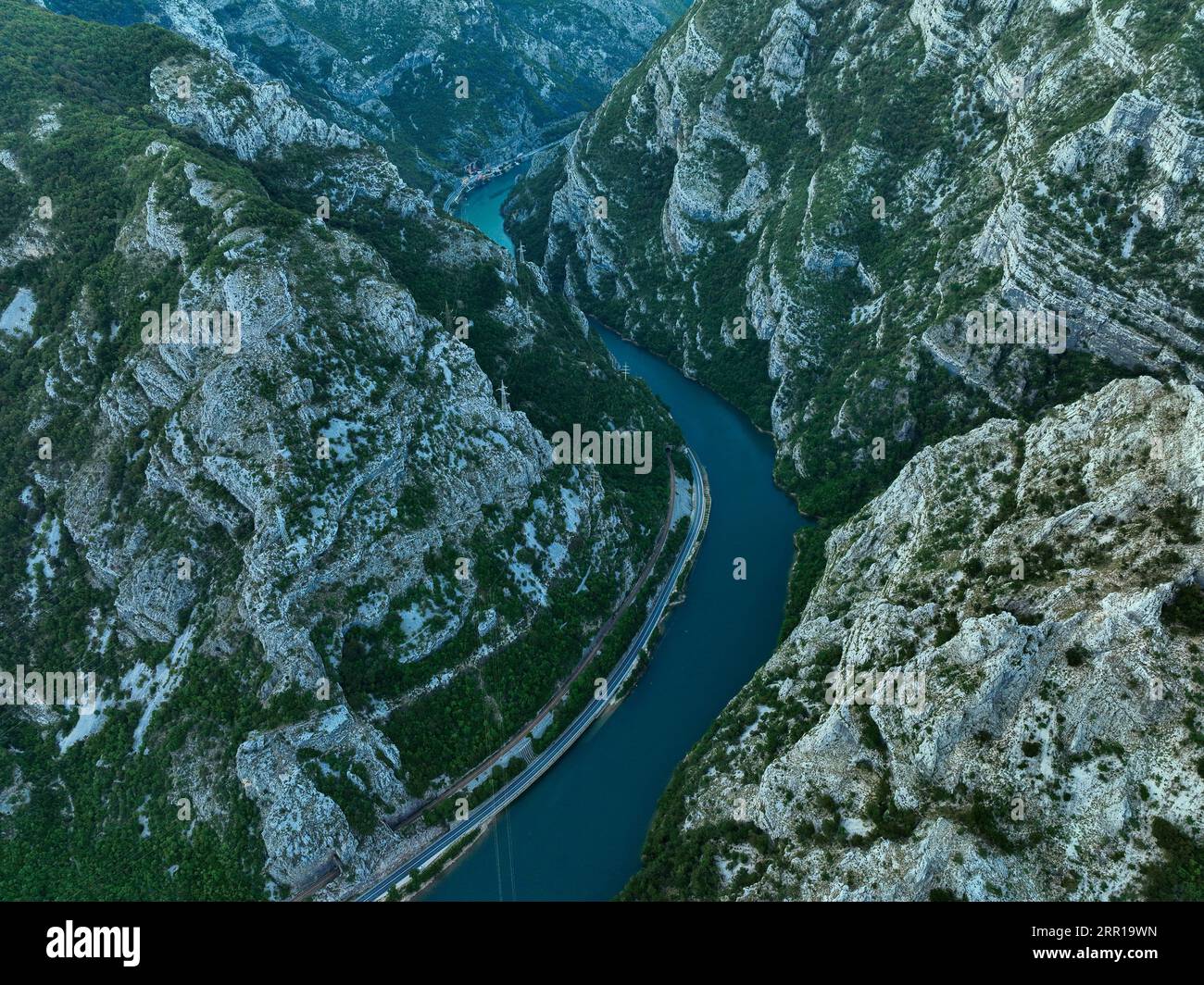 An aerial view of a river flowing through green mountains Stock Photo ...