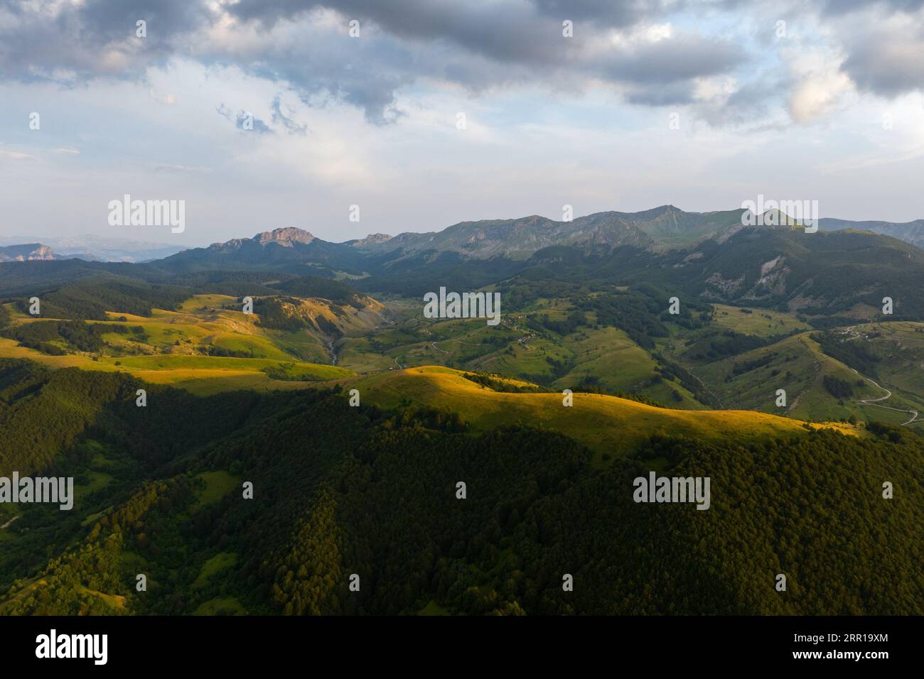 An aerial view of green hills at sunset Stock Photo - Alamy