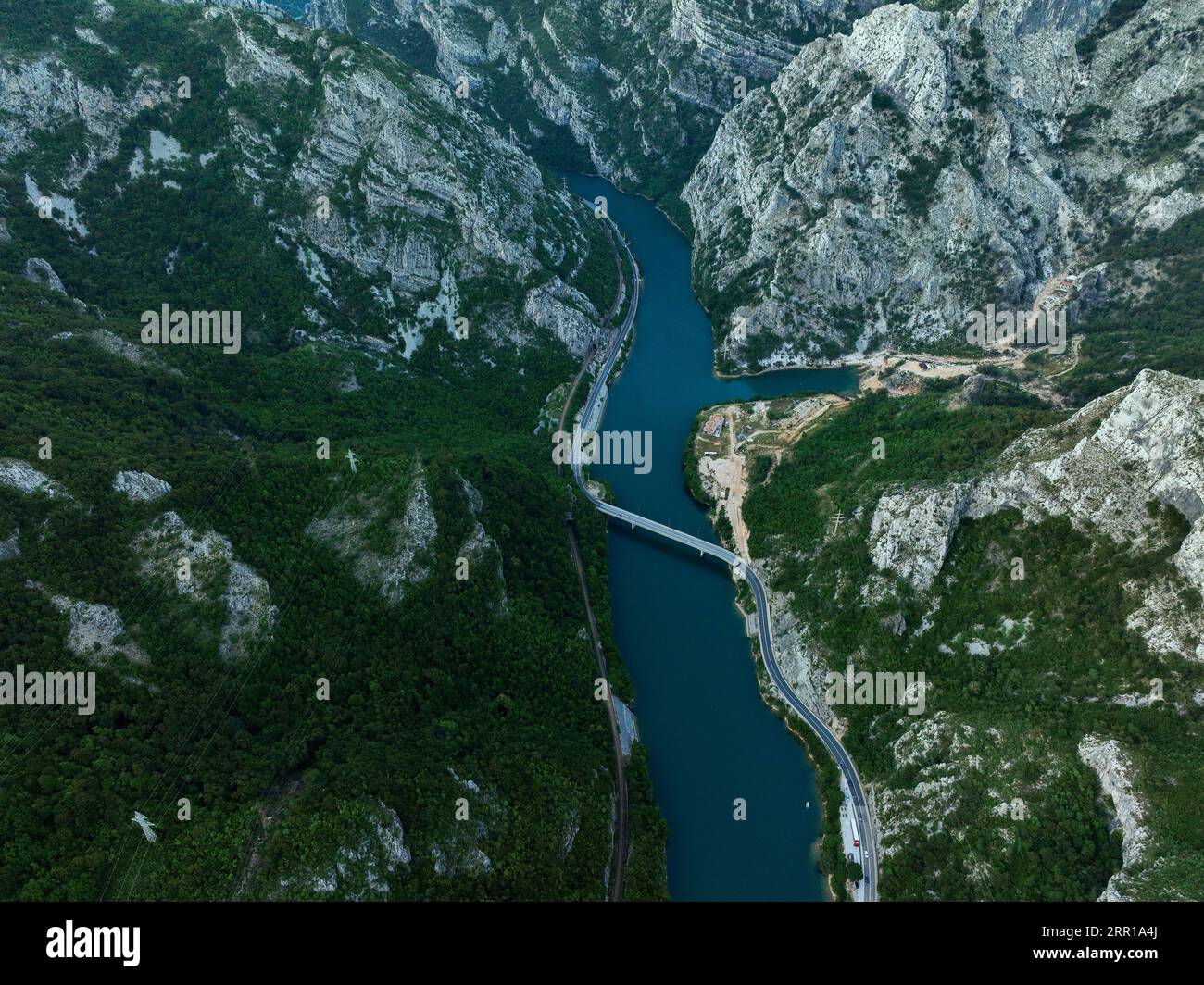 An aerial view of a river flowing through green mountains Stock Photo ...
