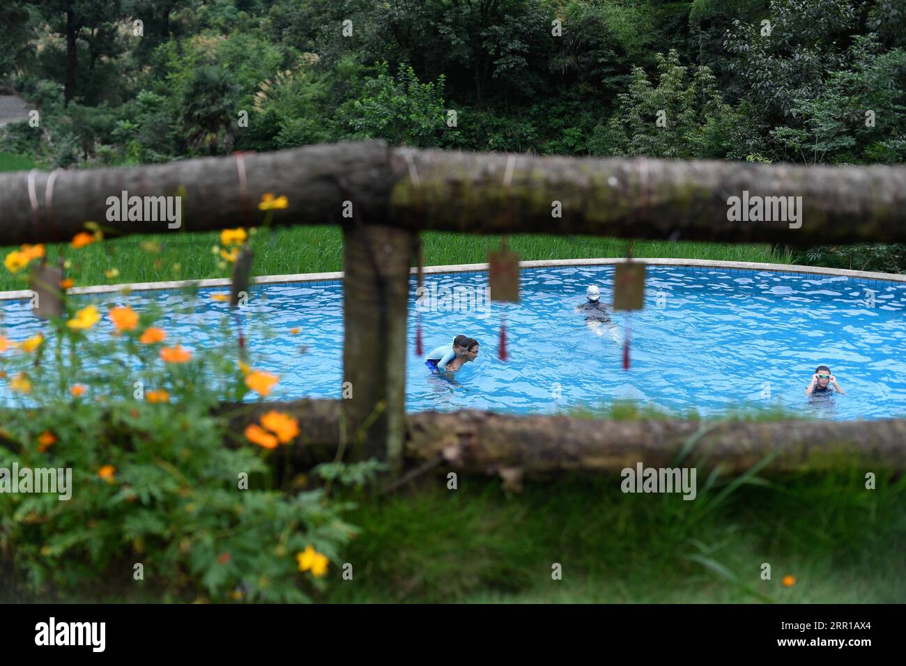 200911 -- HANGZHOU, Sept. 11, 2020 -- Tourists swim at a homestay in Daijiashan Village of Tonglu County, east China s Zhejiang Province, July 18, 2020. In the past 15 years, guided by the conviction that lucid waters and lush mountains are invaluable assets , a large number of villages in Zhejiang Province have undergone environmental transformations, attracting capital investments back to the countryside and prompting the development of homestay tourism. As a pioneer and explorer in the development of homestay business in China, Zhejiang is striving to be the model and destination of homesta Stock Photo