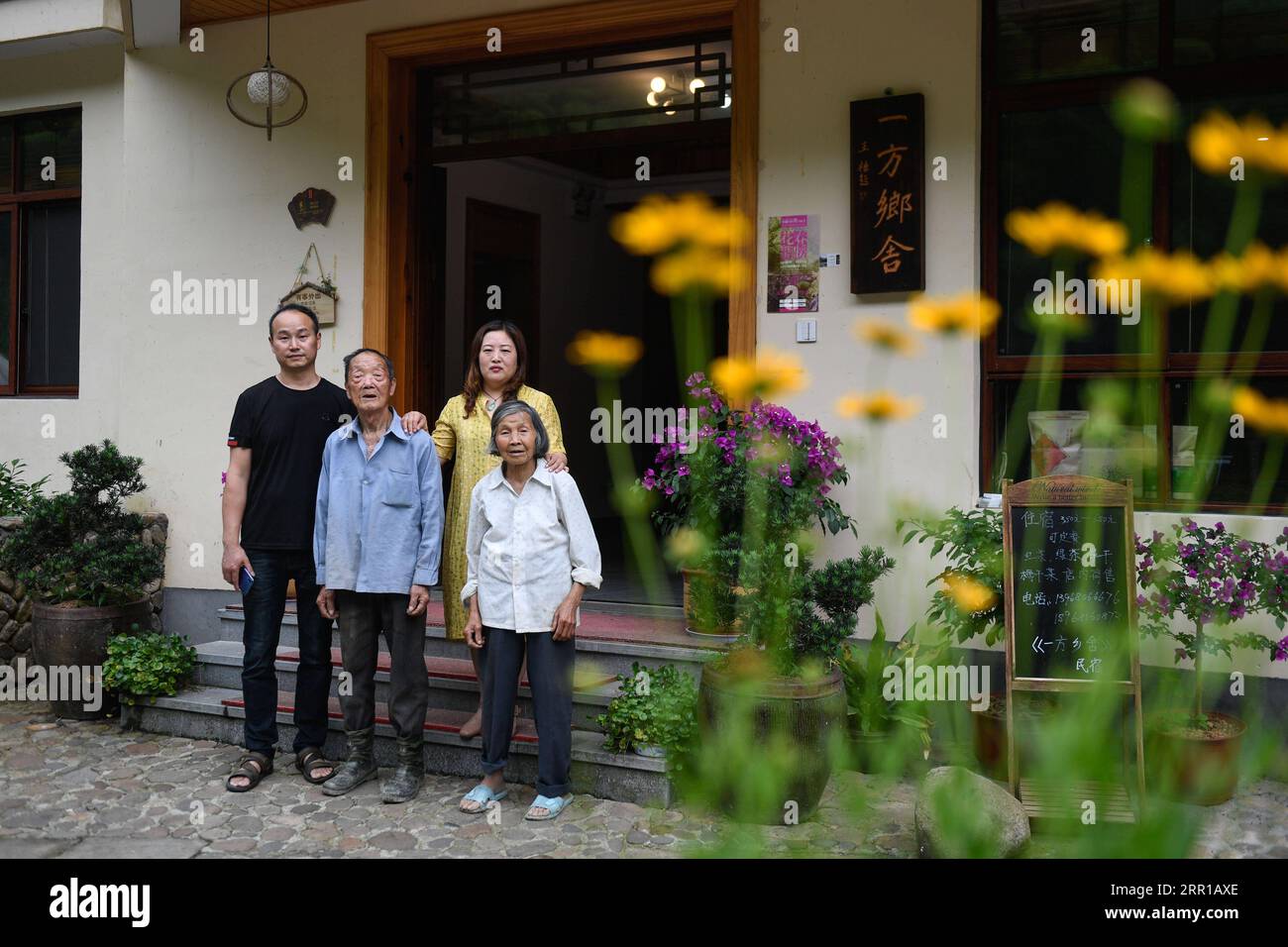 200911 -- HANGZHOU, Sept. 11, 2020 -- Fang Dunwei 1st L, owner of a homestay, poses for a group photo with his family members at Shishe Village in Tonglu County, east China s Zhejiang Province, May 26, 2019. In the past 15 years, guided by the conviction that lucid waters and lush mountains are invaluable assets , a large number of villages in Zhejiang Province have undergone environmental transformations, attracting capital investments back to the countryside and prompting the development of homestay tourism. As a pioneer and explorer in the development of homestay business in China, Zhejiang Stock Photo