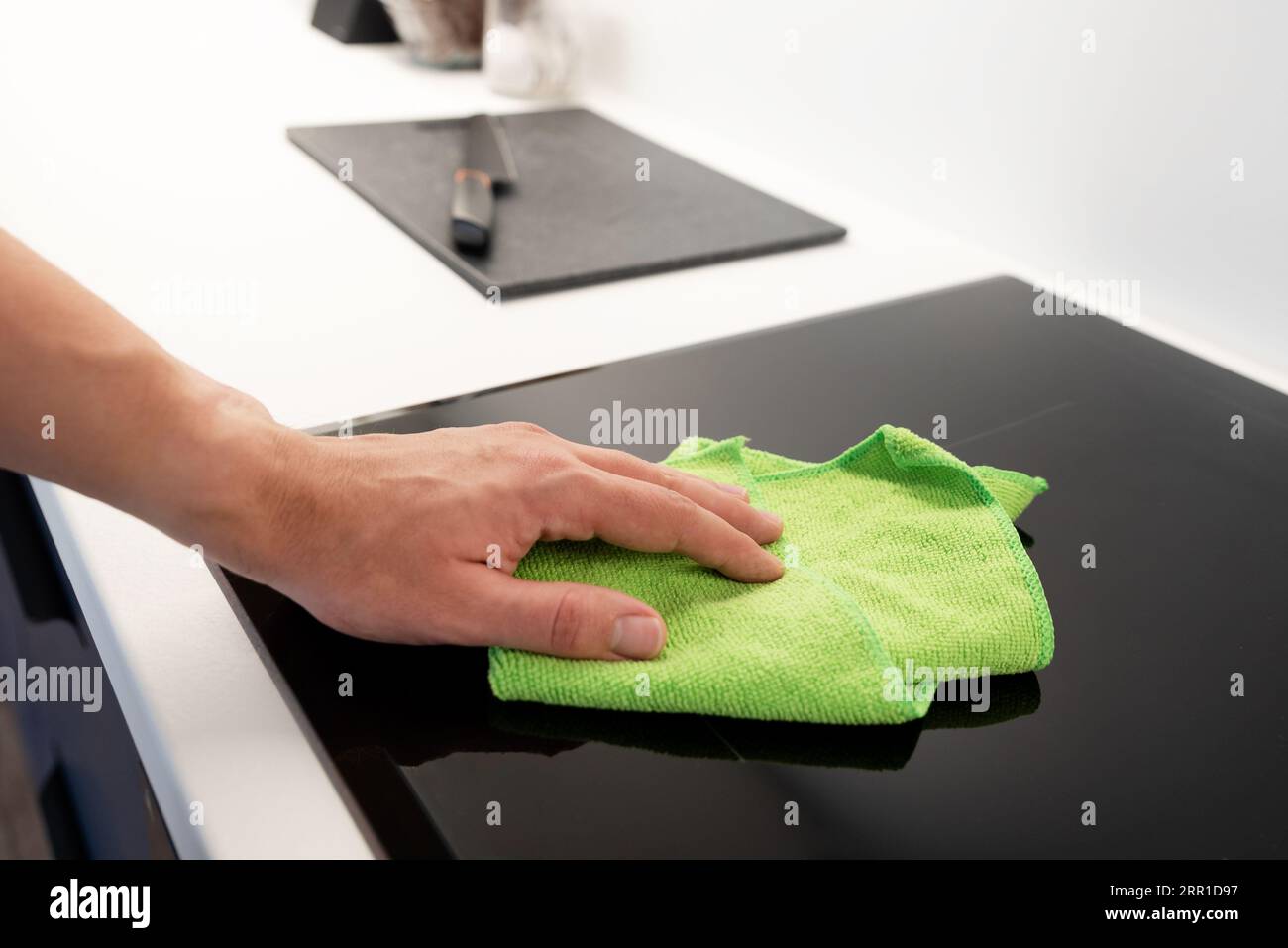 Man cleaning induction stove. Modern kitchen with induction hob Stock