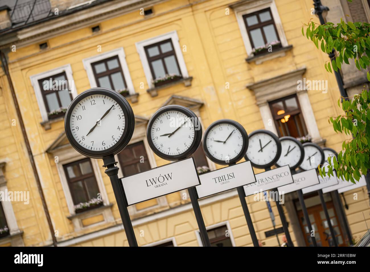 Clocks showing the current time in different cities around the world. Holy Ghost square in Krakow, Poland Stock Photo
